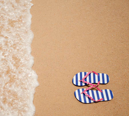 Colorful flipflop pair on sea beach top viewの写真素材