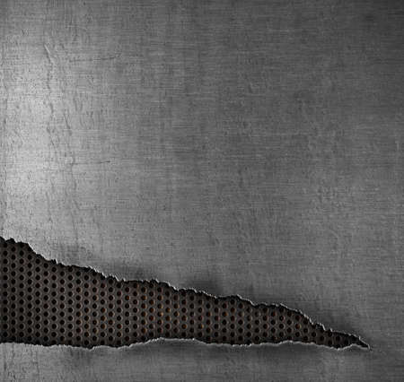 grunge metal background with ripped holeの写真素材
