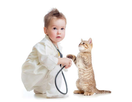 kid or child playing doctor with stethoscope and cat isolated on whiteの写真素材