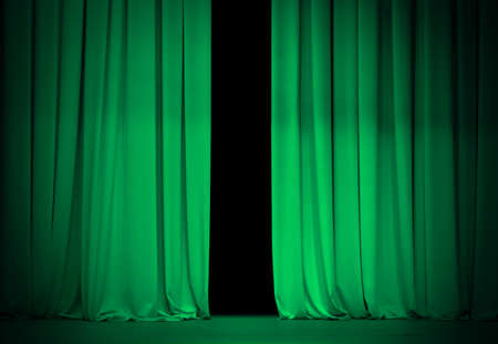 green or emerald curtain on theater or cinema stage slightly openの写真素材