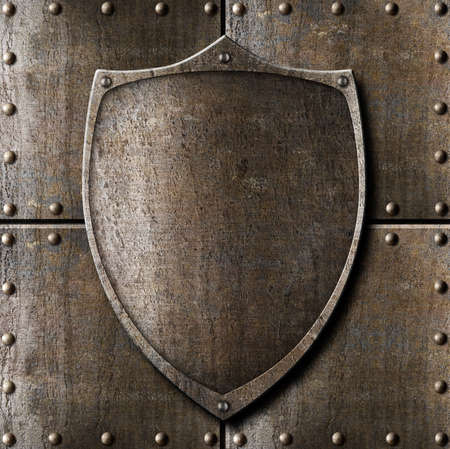 old metal shield over armour background with rivetsの写真素材