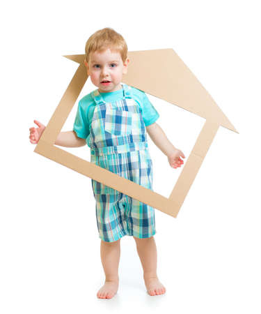 Adorable boy in own cardboard home or room conceptの写真素材