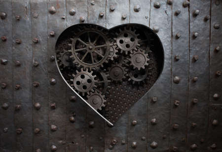 heart hole in old metal with gears and cogsの写真素材