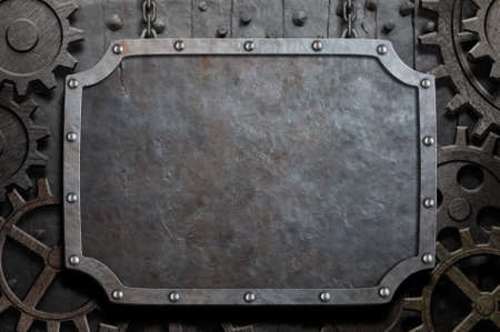 Metal plate hanging on chains over medieval gears and cogsの写真素材