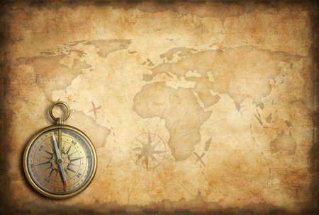 old brass or golden compass with world map backgroundの写真素材