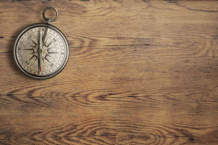 old compass on vintage wooden table top viewの写真素材