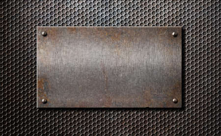 old rusty metal plate over comb grid or grille backgroundの写真素材