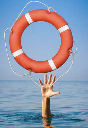Lifebuoy for drowning man\'s hand in open sea or ocean water.の写真素材
