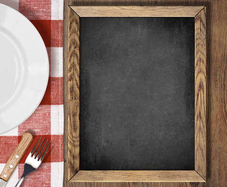 Menu chalkboard top view on table with plate, knife and forkの写真素材