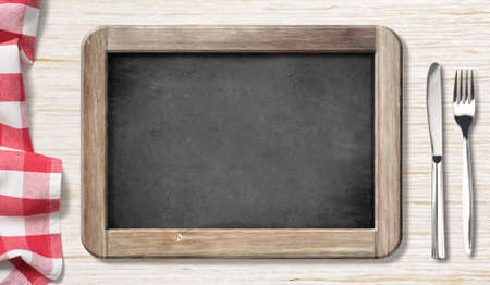 Menu blackboard top view on table with knife and forkの写真素材