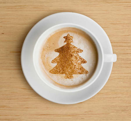 coffee cup with foam and christmas tree shapeの写真素材