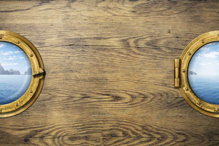 Two ship windows or portholes with tropical sea or ocean island. Travel and adventure concept.の写真素材
