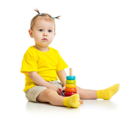baby playing with colorful wood pyramid isolatedの写真素材
