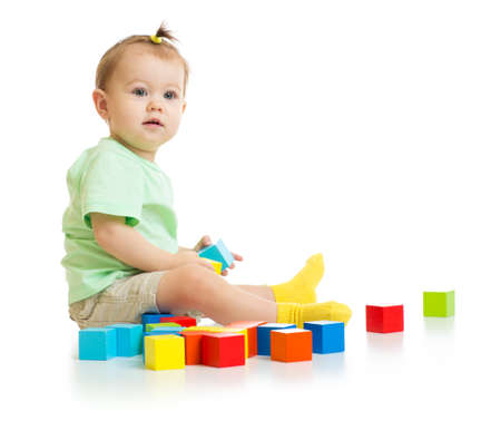 baby playing with colorful blocks isolatedの写真素材