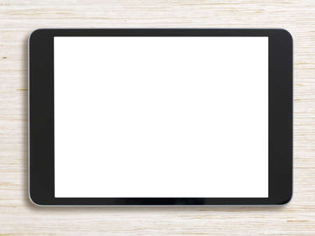 Black tablet pc on bleached wood backgroundの写真素材