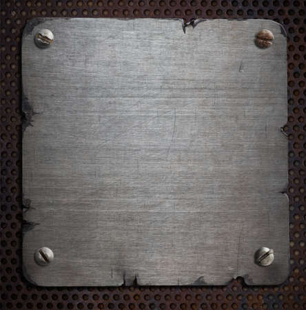 rusty metal plate with torn edges backgroundの写真素材