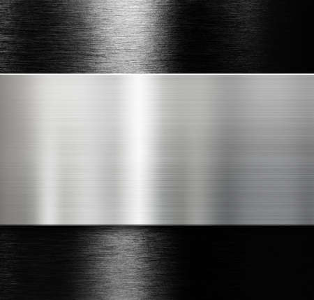 metal plate over black brushed aluminumの写真素材