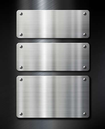three stainless steel metal plates on black brushed backgroundの写真素材