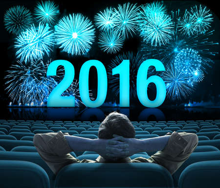 2016 happy new year fireworks with man sitting alone in auditoriumの写真素材