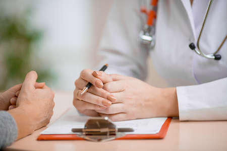 Doctor consulting patient in her officeの写真素材