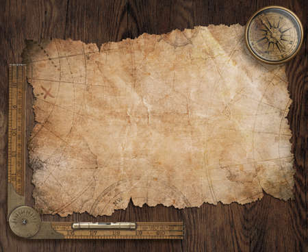 Pirates' old treasure map on wooden desk with compass and ruler 3d illustrationの写真素材