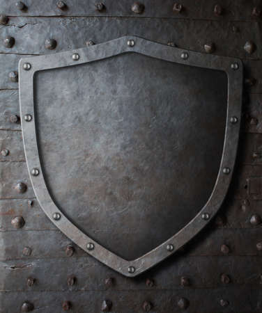 old medieval coat of arms shield over metal door background with rivets 3d illustrationの写真素材