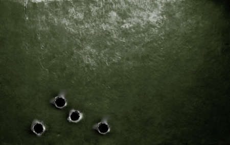 metal green military armor background with bullet holesの写真素材