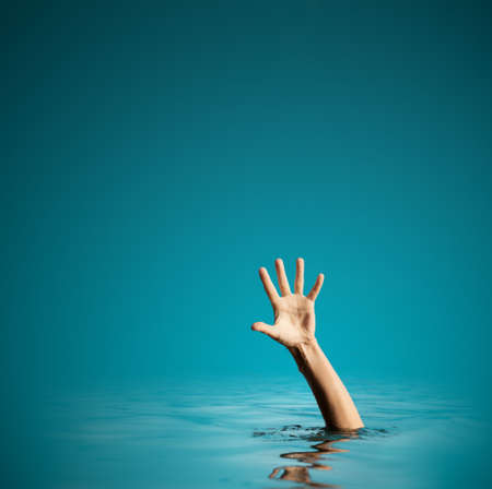 Hand on sea water background asking for help