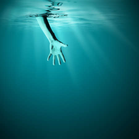 Giving helping hand in sea underwaterの写真素材