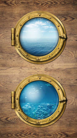 Two vertical ship windows with ocean surface and underwaterの写真素材