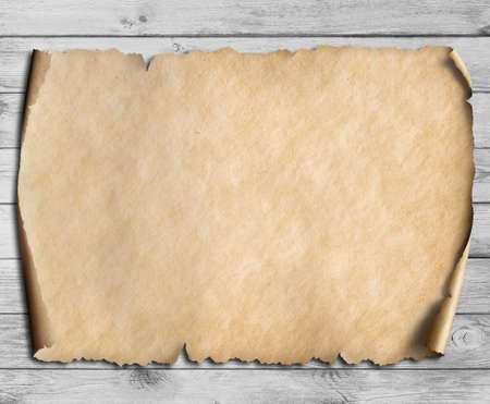 vintage scroll or map on wooden tableの写真素材