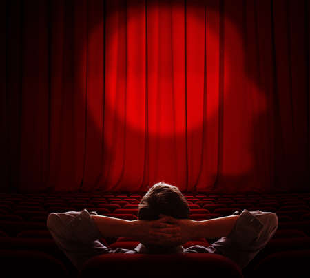 man sitting alone in dark hall and looking on his brain curtainの写真素材