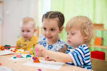kids doing arts and crafts in day care centreの写真素材