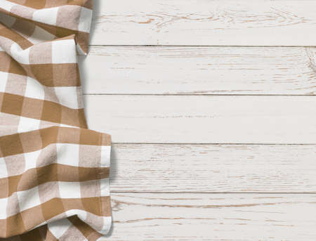 brown folded tablecloth with white wooden tableの写真素材