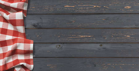 red folded tablecloth with black wooden tableの写真素材