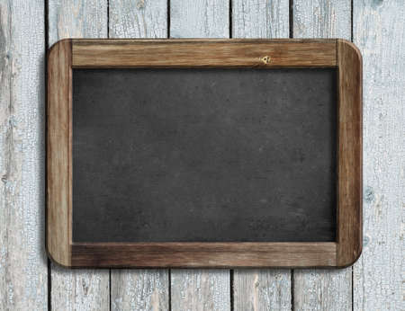 Aged menu blackboard hanging on white wooden wallの写真素材