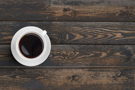coffee cup on dark wooden table top viewの写真素材