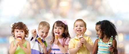 kids group eating ice cream at a party in cafeの写真素材