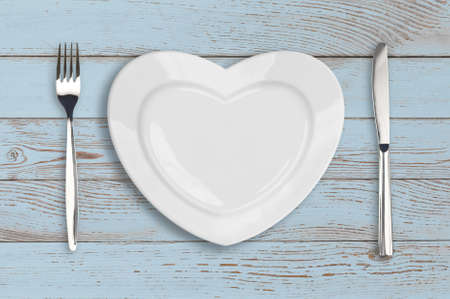 empty heart plate top view on blue wood tableの写真素材