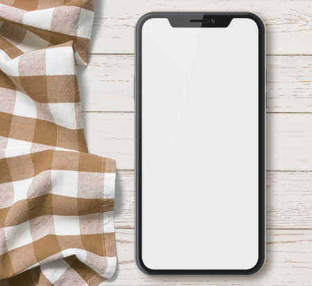 new smartphone top view on old wood table with clothの写真素材