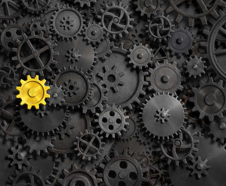 Rusty gears and cogs and one goldの写真素材