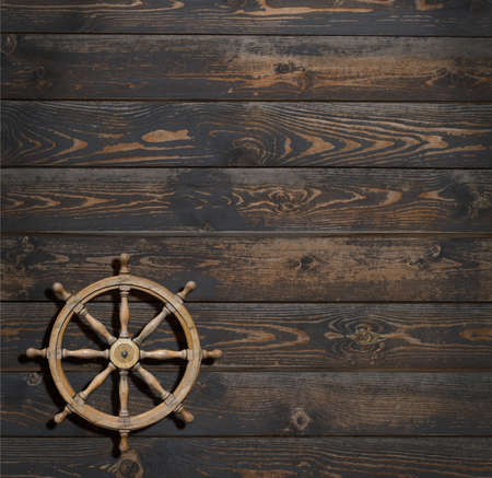 steering wheel on dark wood backgroundの写真素材