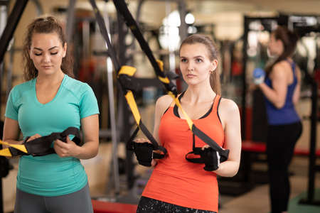 Womans making fitness excercise in gymの写真素材