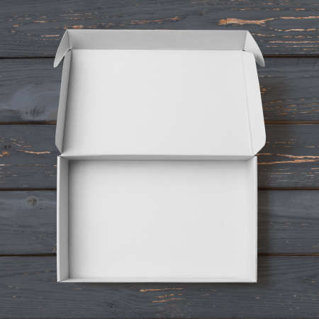 Open white cardboard box top view on black painted woodの写真素材