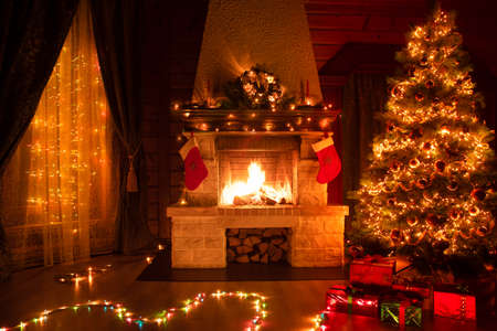 Christmas decorated living room interior with fireplace, armchair, window and xmas treeの写真素材