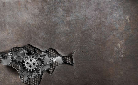 Torn hole metal background with gears and cogs 3d illustrationの写真素材