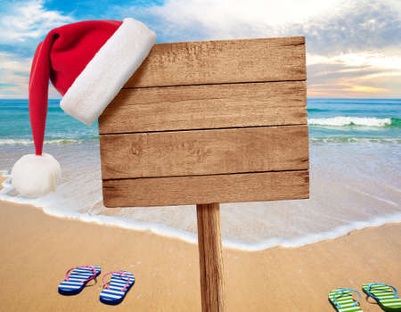 Christmas beach party signboard with flip-flopsの写真素材