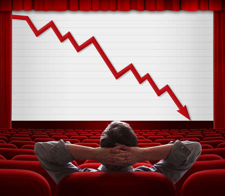 Man sitting and looking on screen with financial diagramの写真素材