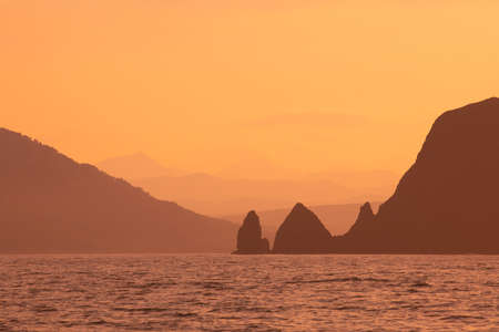 Abstract orange sunset mountains and sea natural backgroundの写真素材