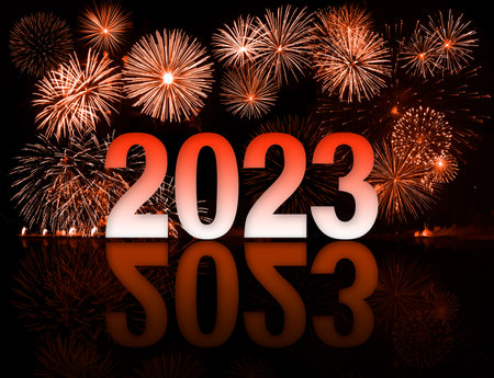 2023 new year red an white digits in front of fireworksの写真素材